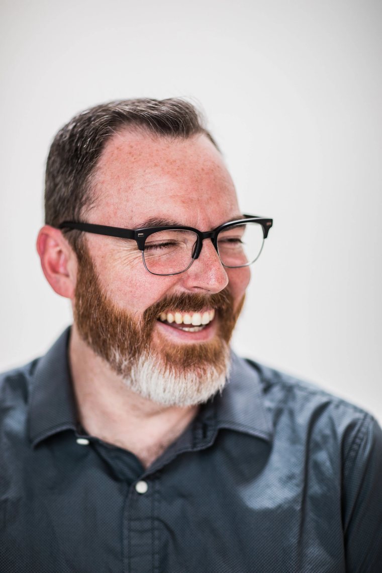 Mike McHargue laughing, looking off-camera